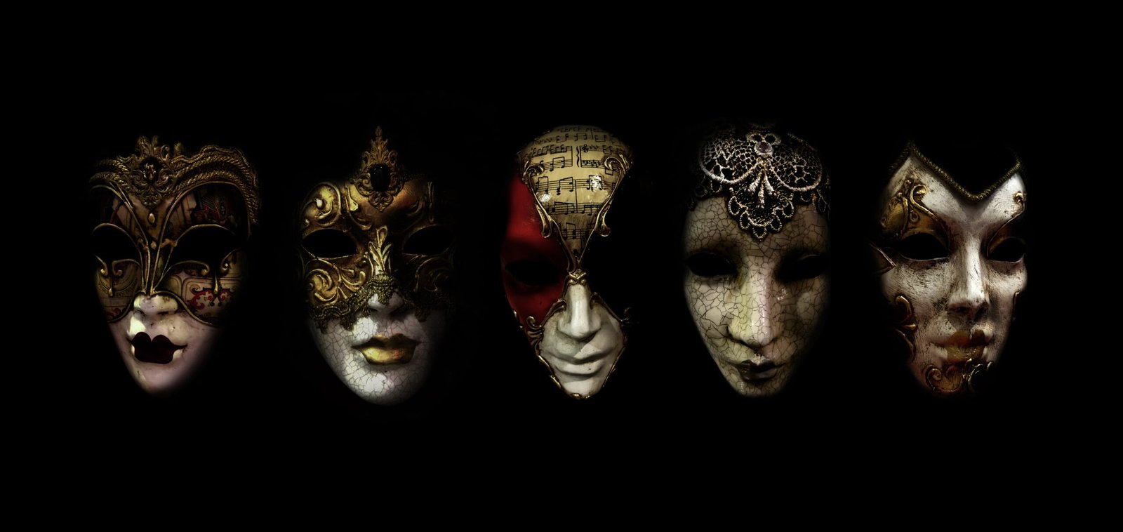 a row of different colored masks on a black background